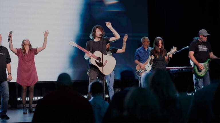 Photo of Liberty Church Milton Campus' worship team singing and leading the congregation in worship